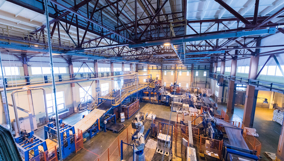 Factory workshop interior and machines on glass production background